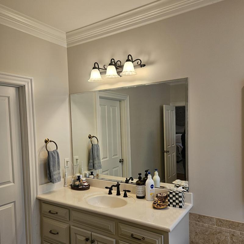 Bathroom sink and countertop with mirror and lighting