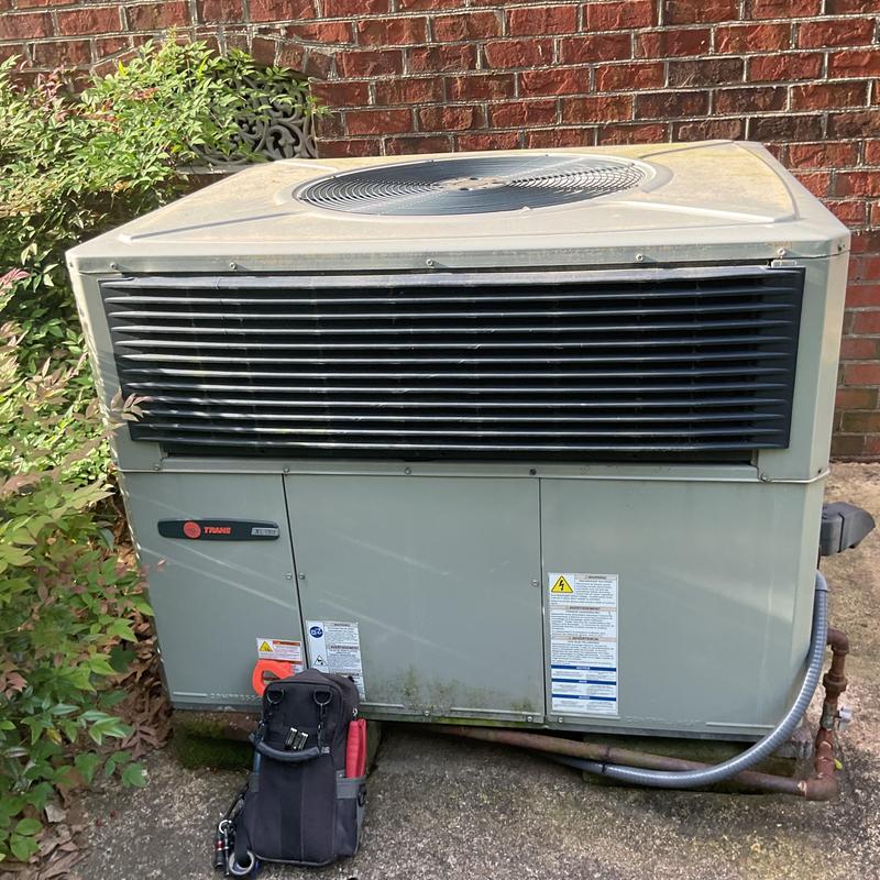 Air conditioner unit outdoor condenser with HVAC tool bag