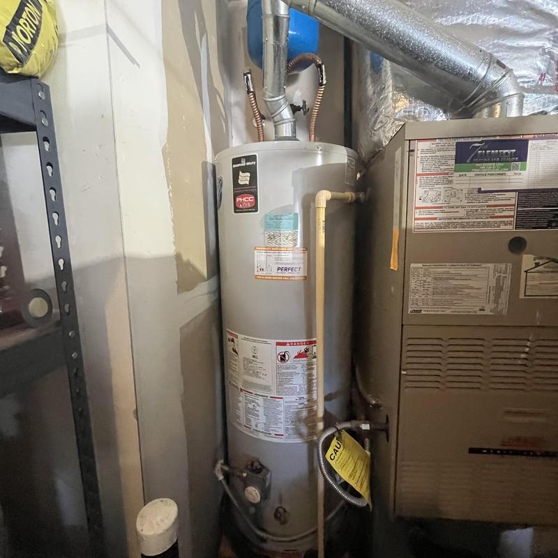 Gas water heater with venting and piping system
