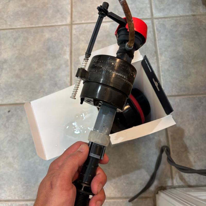 Toilet flush valve rod cylinder replacement in hand