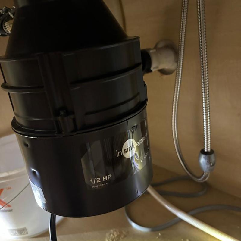 Garbage disposal unit installed under kitchen sink