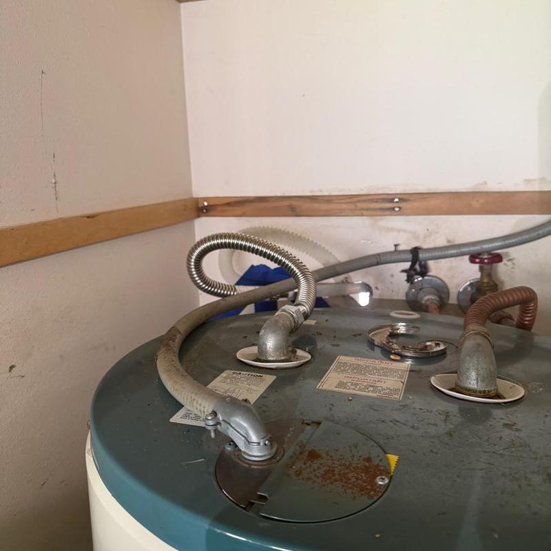 Water heater old supply and vent piping connections