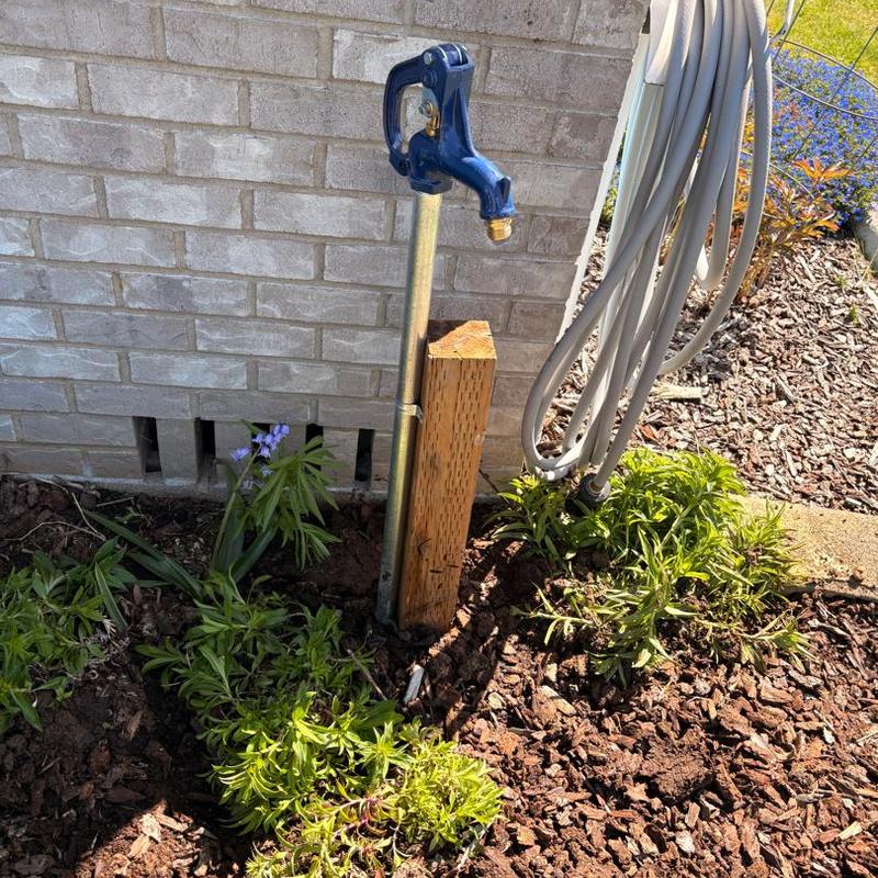 Yard hydrant with ground stake and drainage rock
