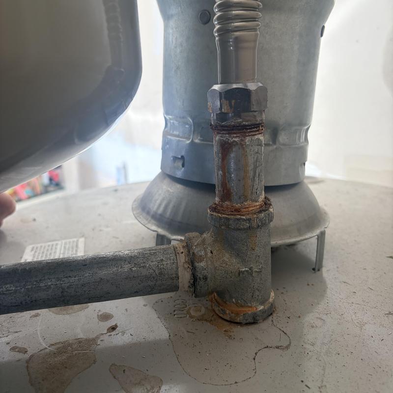 Galvanized water heater fittings showing corrosion