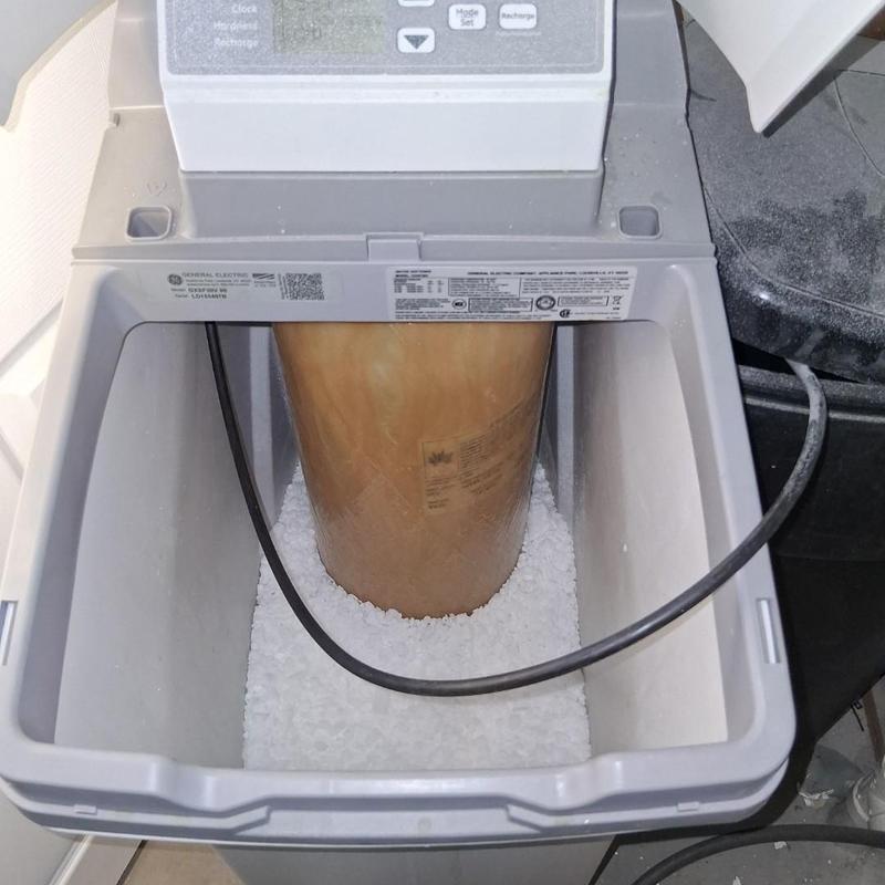Water softener salt refill with control valve visible