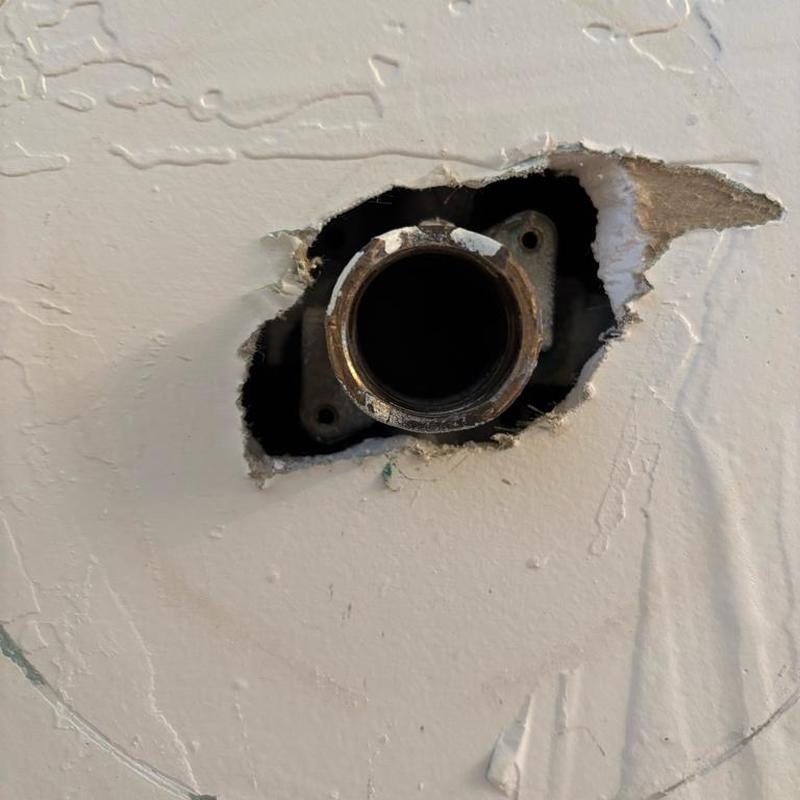 Tub cartridge housing exposed in wall hole