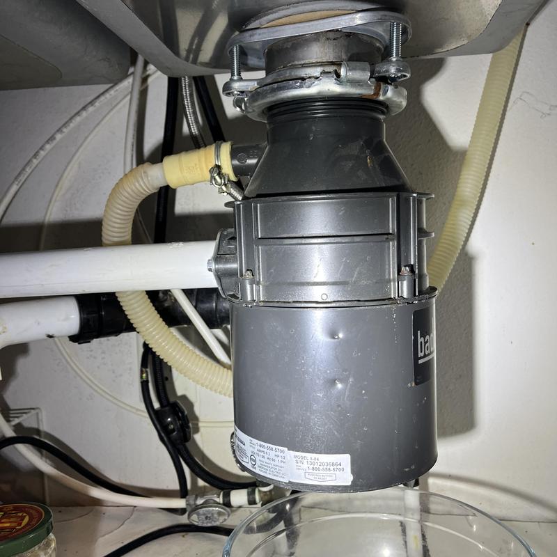 Garbage disposal unit under kitchen sink with piping