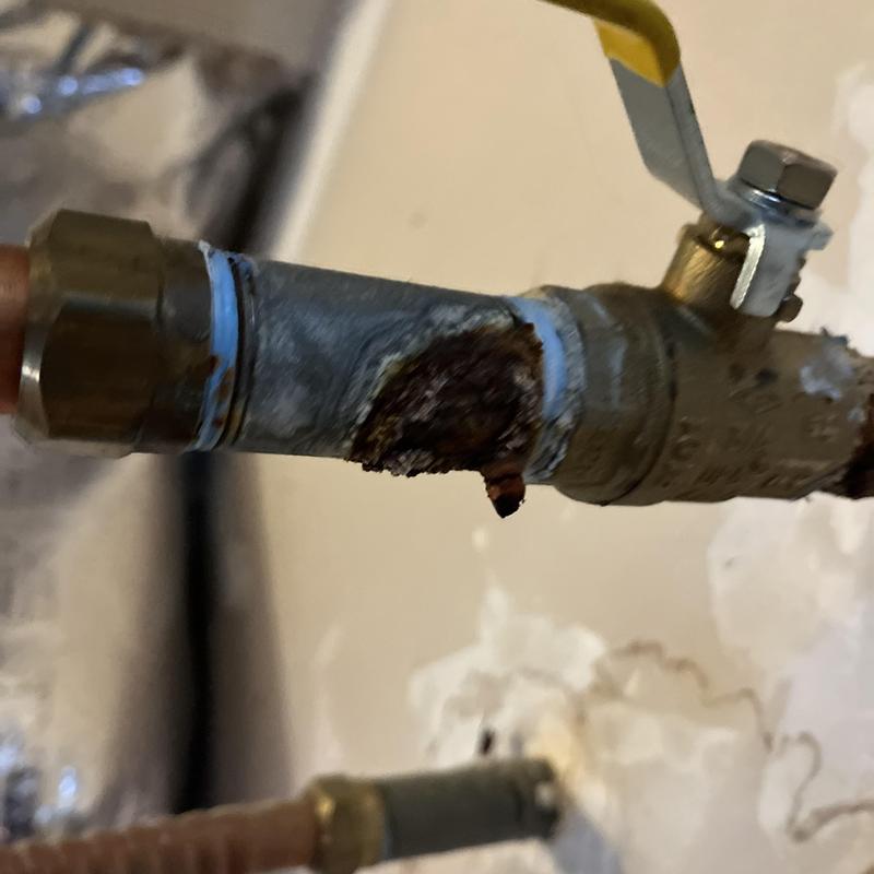 Corroded metal water pipe with valve and threaded fitting