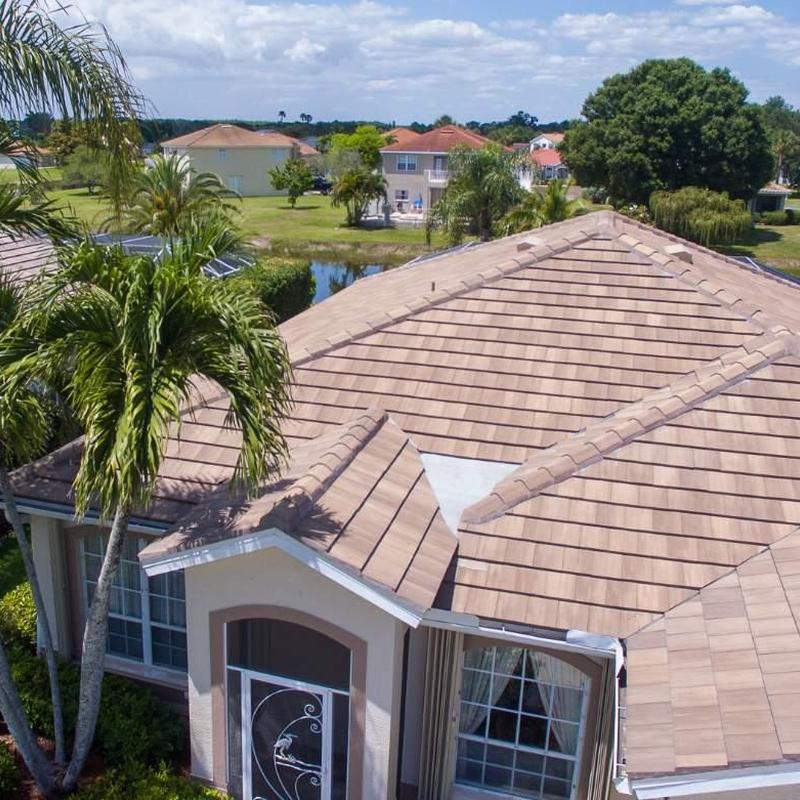 Concrete tile roof with repaired ridge and valley sections