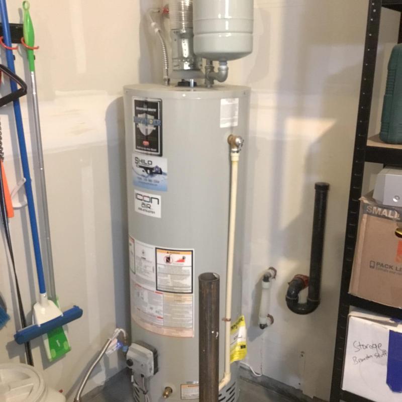 Water heater T&P valve replacement setup in utility room