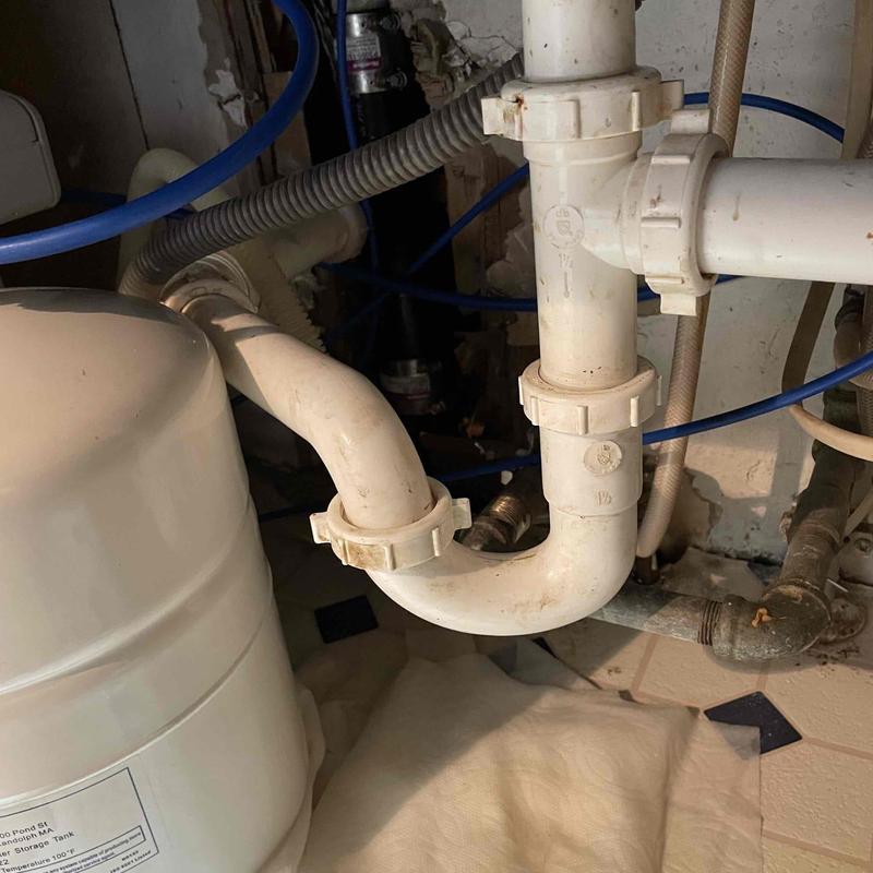 PVC kitchen sink P-trap and drain pipes under sink