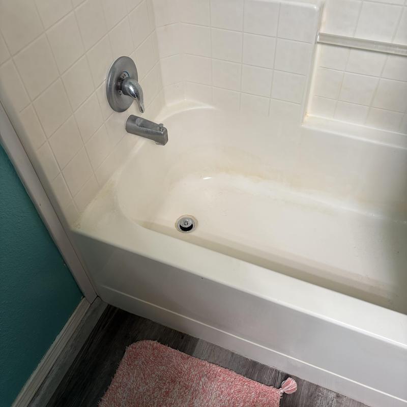 Chrome bathtub stopper installed in tub shower drain