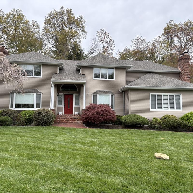 Asphalt shingle roof on two-story suburban house