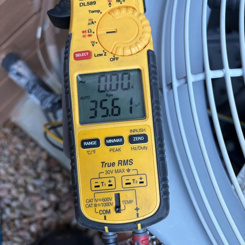 Clamp meter measuring HVAC condenser electrical current