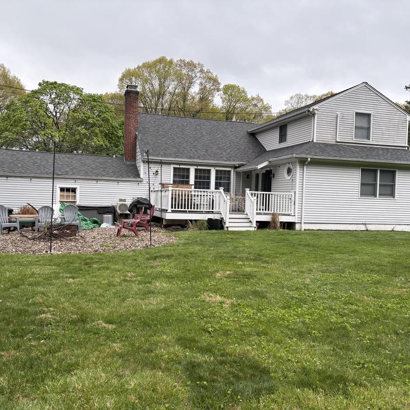Asphalt shingle roof installation on white home
