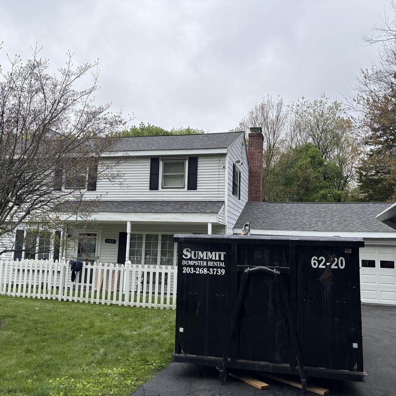 Asphalt shingle roof installation on two-story house