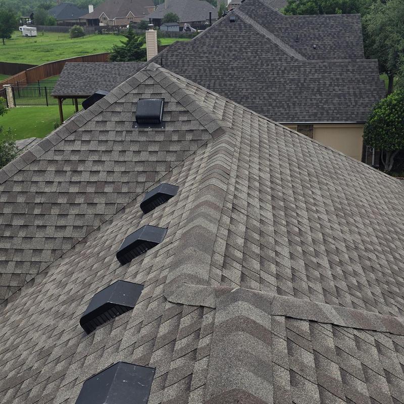 Asphalt shingle roof with ventilation vents and ridges