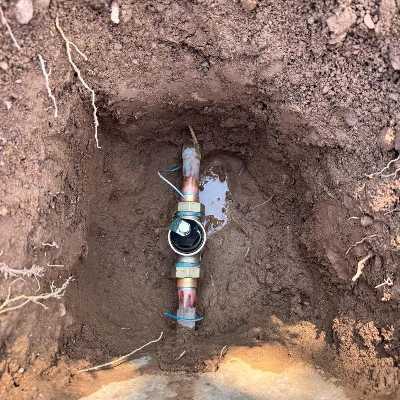 Water main with pressure reducing valve installation site