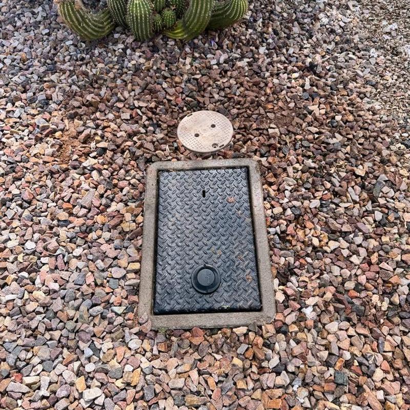 Water main meter box with irrigation valve access in gravel
