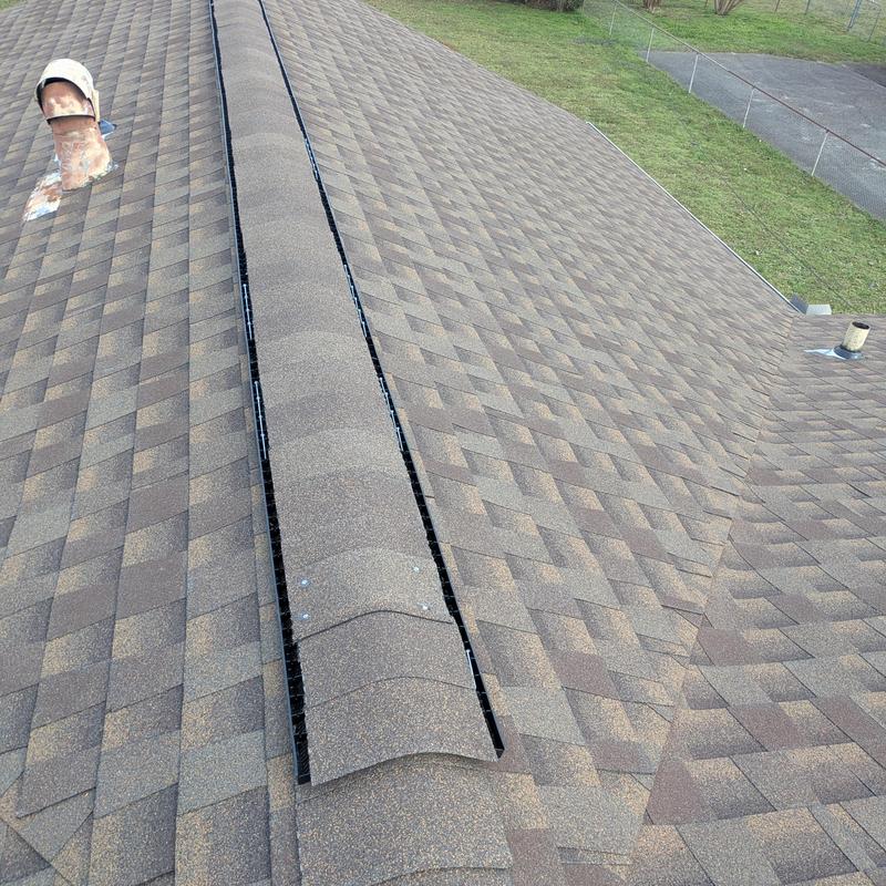 Asphalt shingle roof with new ridge vent installation