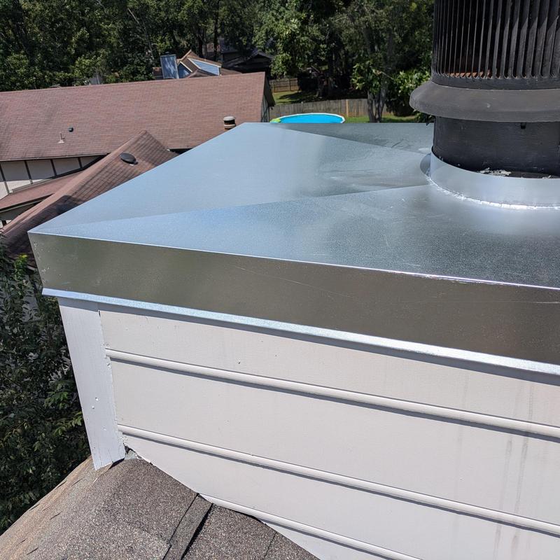 Chimney cap installation on residential roof in Madison