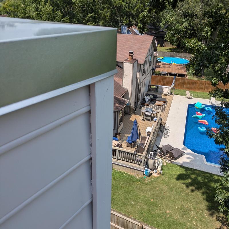 Chimney cap installation on residential roof