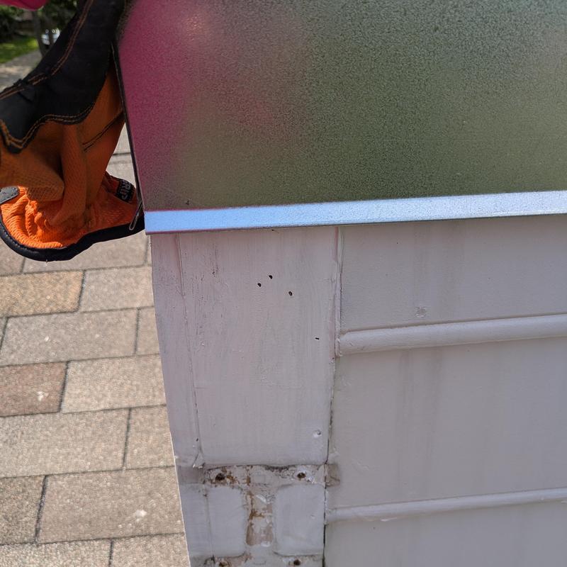 Chimney cap installation on home rooftop