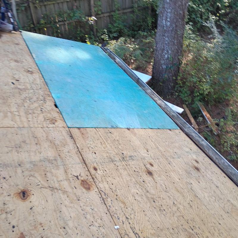 Roof plywood decking with blue underlayment section