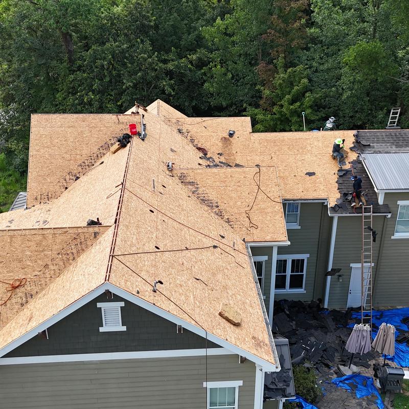 Roof decking installation on residential home with workers
