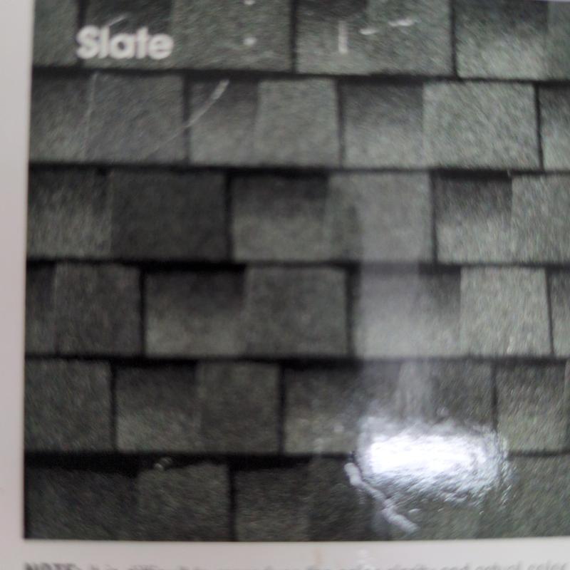 Slate roofing shingles sample with dark gray tones