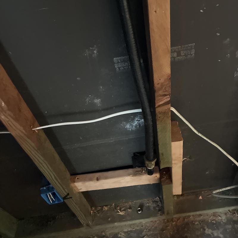 Gas piping system installation under floor joists