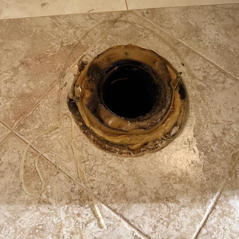 Toilet flange and wax ring on tiled bathroom floor Toilet flange and wax ring on tiled bathroom floor