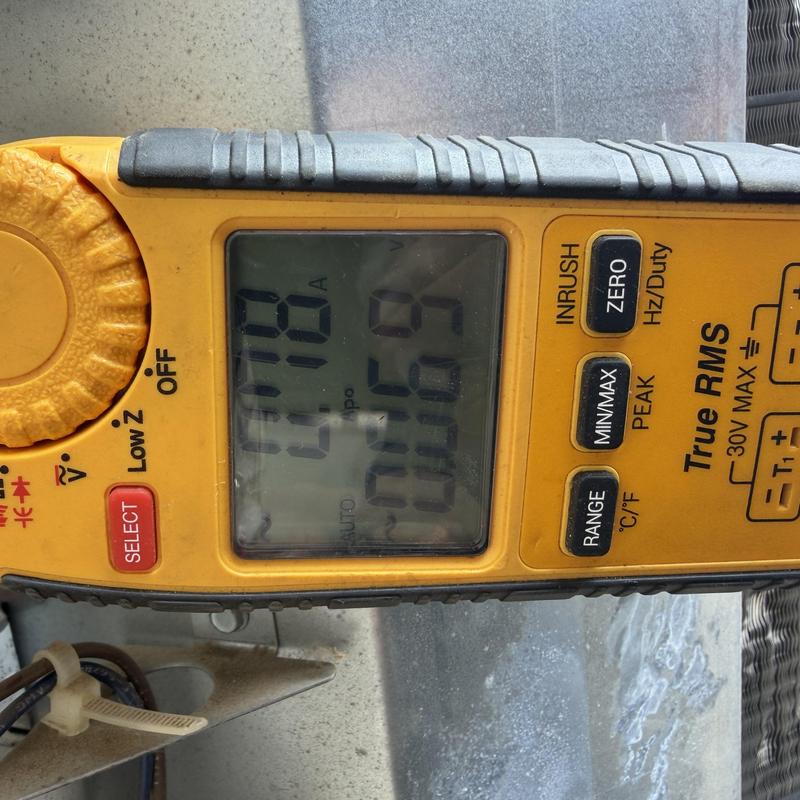 Multimeter measuring current on HVAC system component
