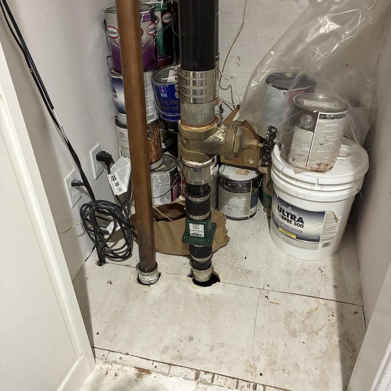 Sump pump discharge pipe with valve and sealant bucket Sump pump discharge pipe with valve and sealant bucket