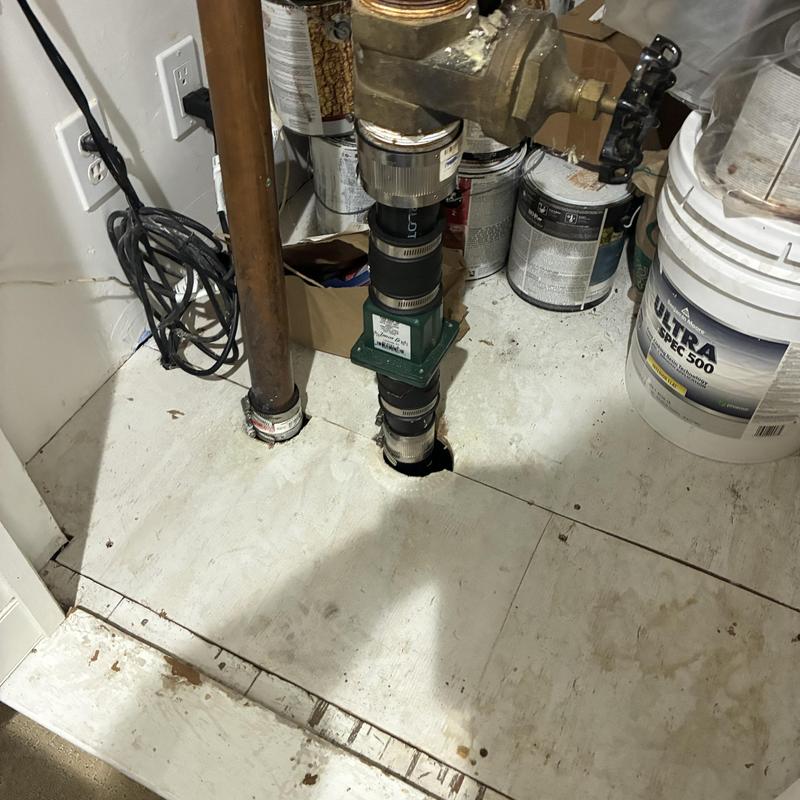 Sump pump discharge pipe and check valve in basement Sump pump discharge pipe and check valve in basement