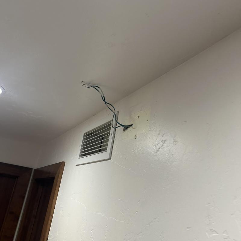 Doorbell chime wiring exposed on interior wall near vent