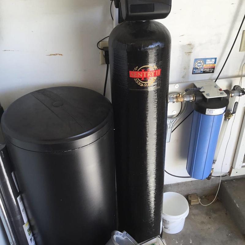Water softener system with filter housing in garage