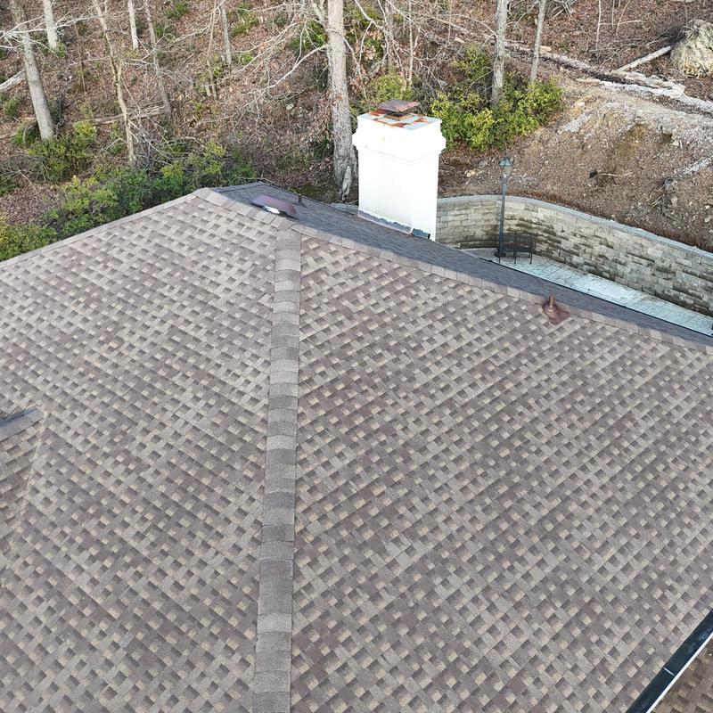 GAF HDZ asphalt shingle roof with chimney near woods