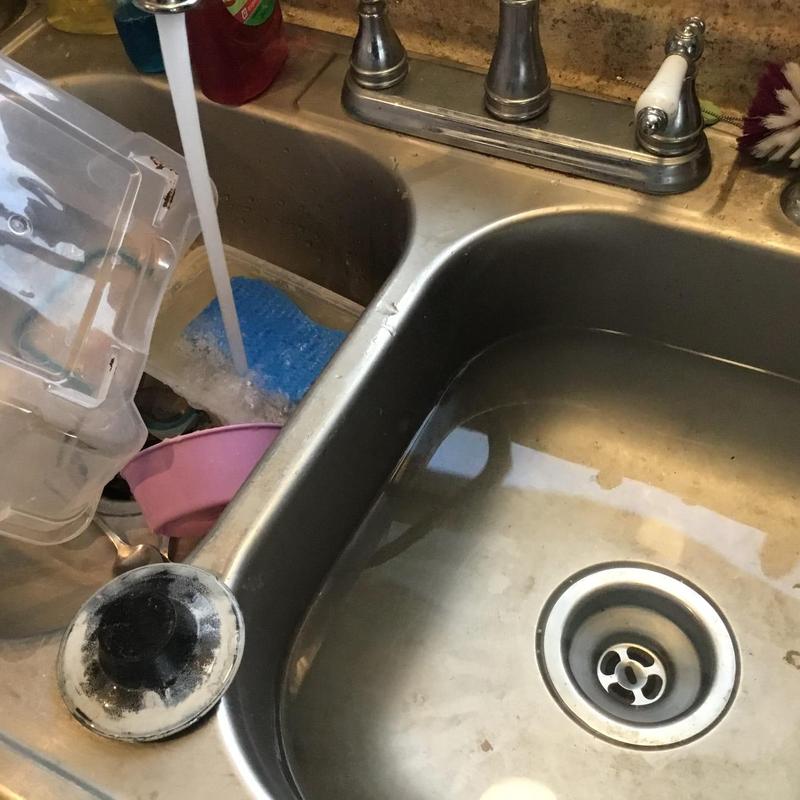 Kitchen sink drain with water running and removed stopper