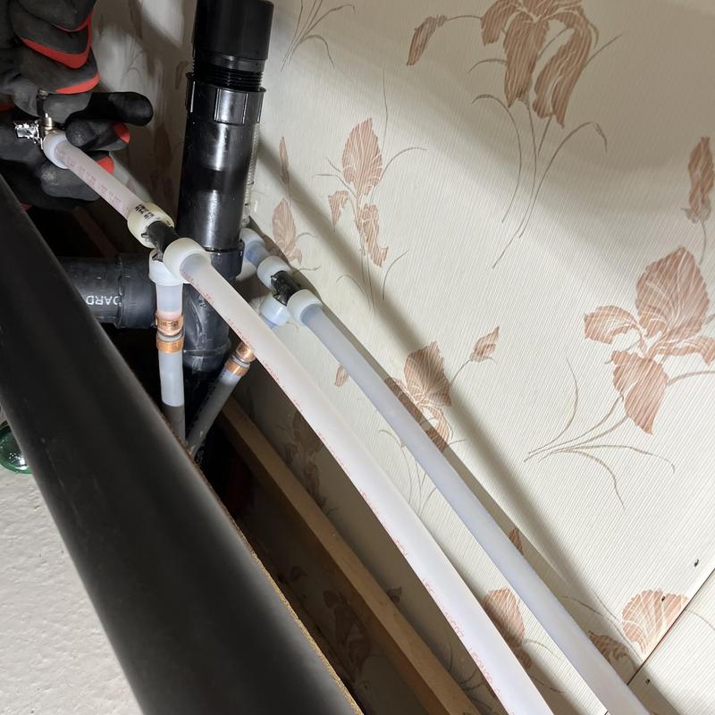 Polybutylene to PEX transition fitting installation under vanity