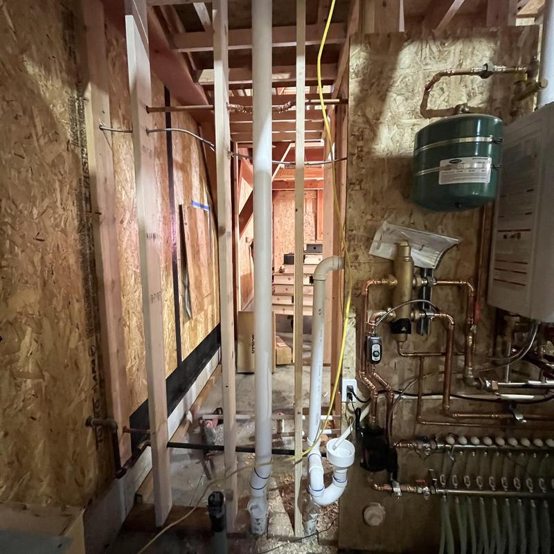Sewer and water pipe installation in wall framing