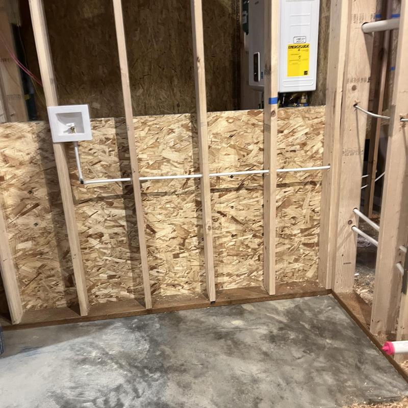 Water pipe and sewer line installed in wall framing