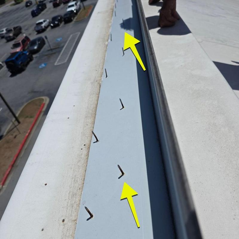 Metal roof panel with bent nails from wind damage Metal roof panel with bent nails from wind damage
