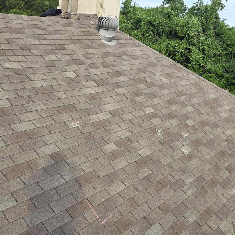 Asphalt shingle roof with hail damage markings