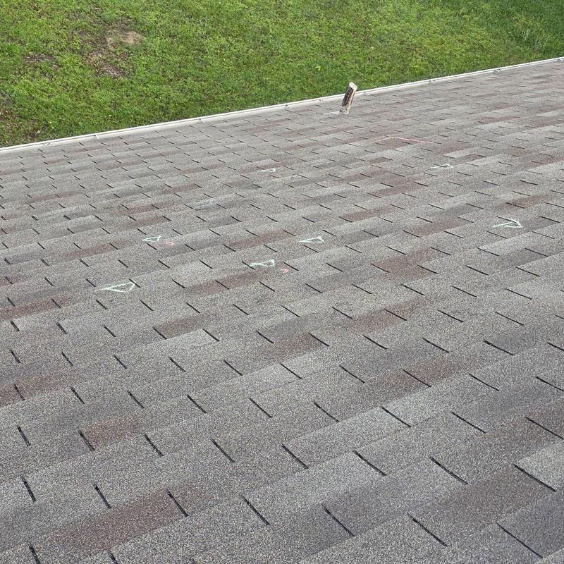Asphalt shingle roof with hail damage markings