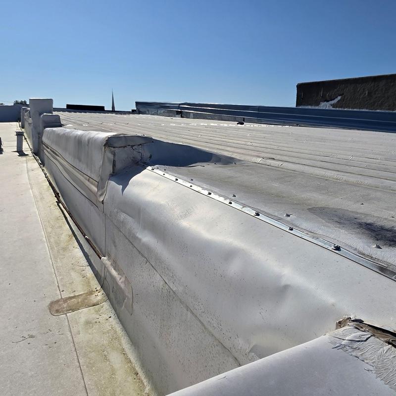 Metal roofing panel with hail damage dents outdoors