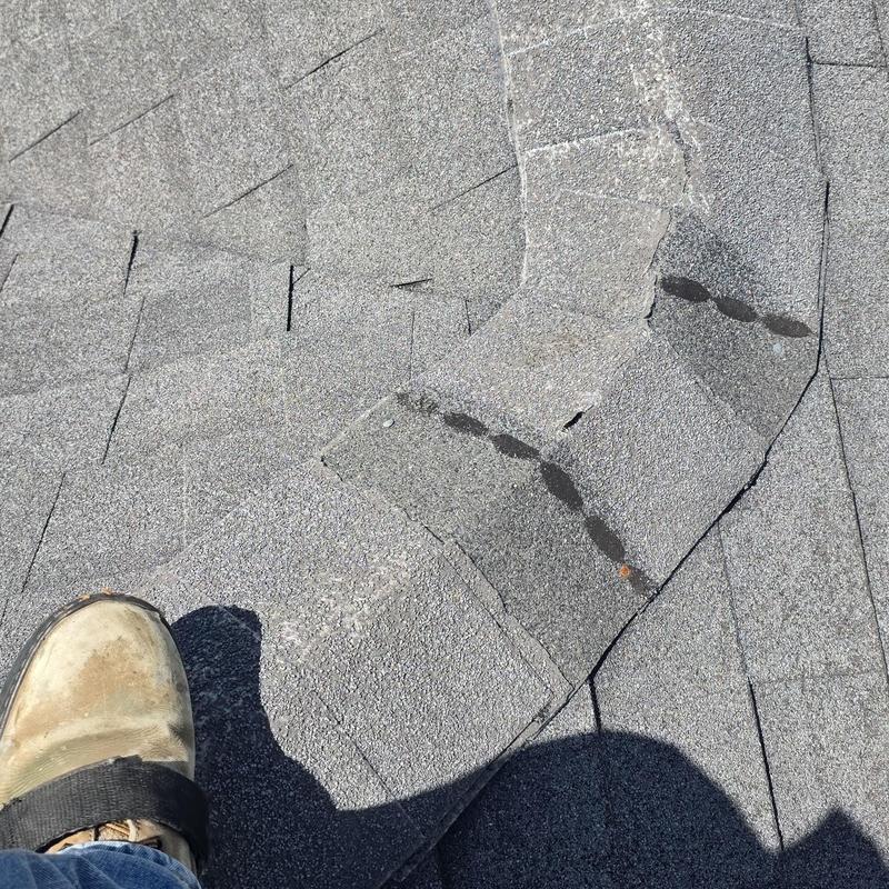 Asphalt shingles with hail damage and repair marks