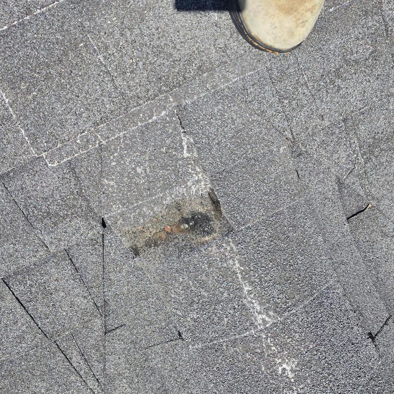 Asphalt shingle roof with hail damage marked by chalk