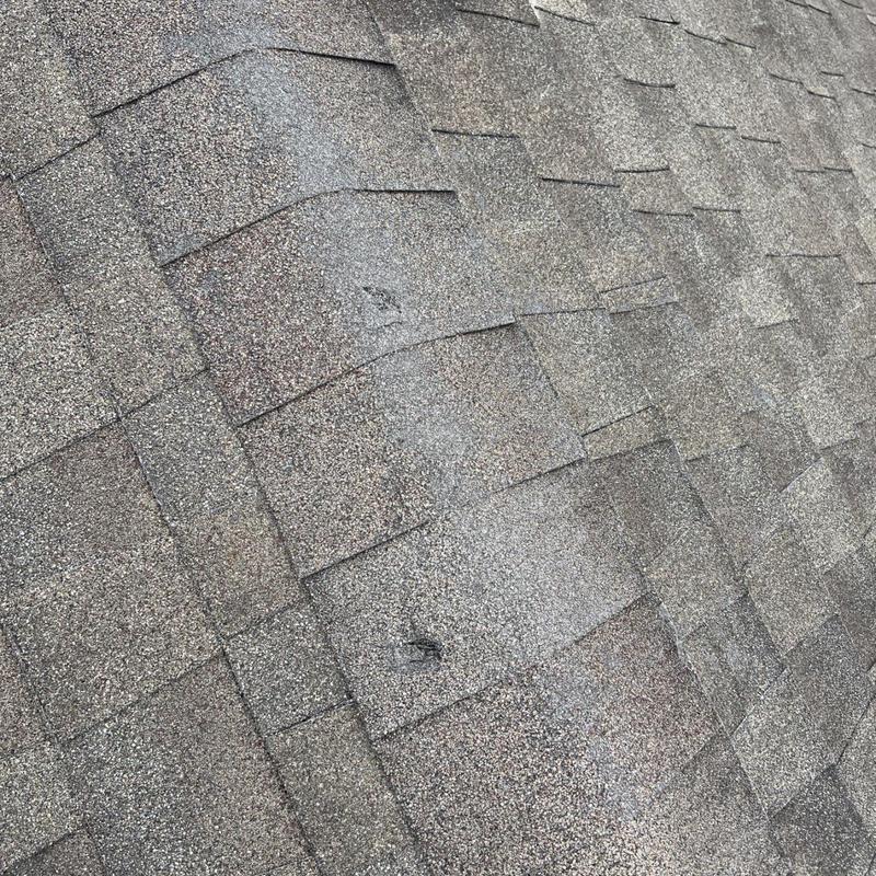 Roof shingles with wear and damaged granules close-up