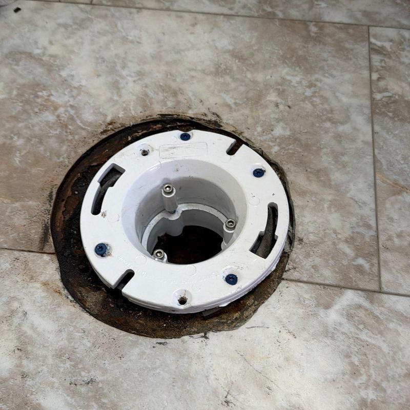 Toilet flange replacement with plastic build-up on tile floor